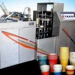Paper cup making machine with stacks of printed cups