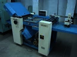 Blue folding machine in a print shop