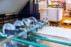 Close-up of folding machine slitter wheels