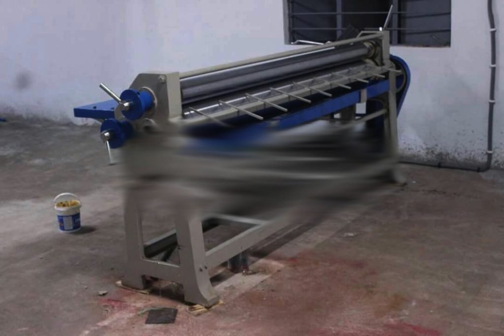 Sheet pasting machine in a workshop